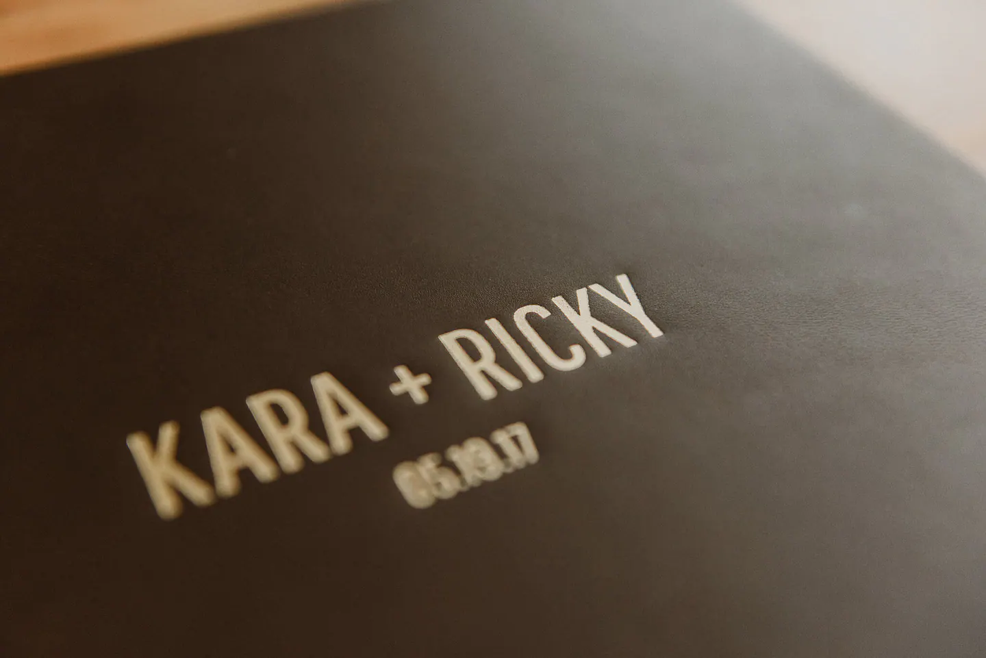 Close detail of gold embossing on a full-grain leather wedding album cover