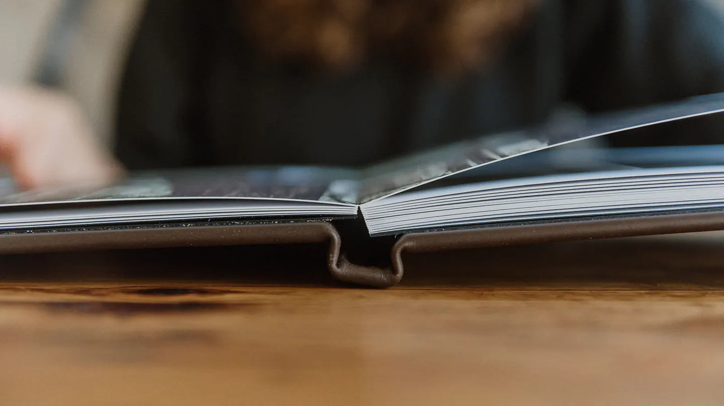Close view of a wedding album binding lying flat at the center seam