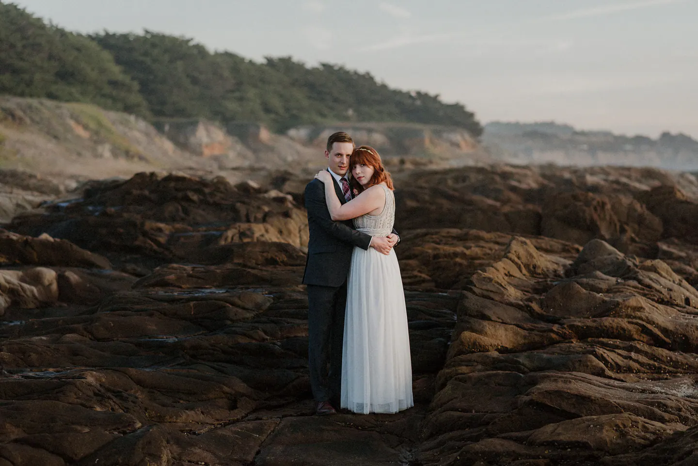 Newlyweds dancing beneath the redwoods during their wedding reception