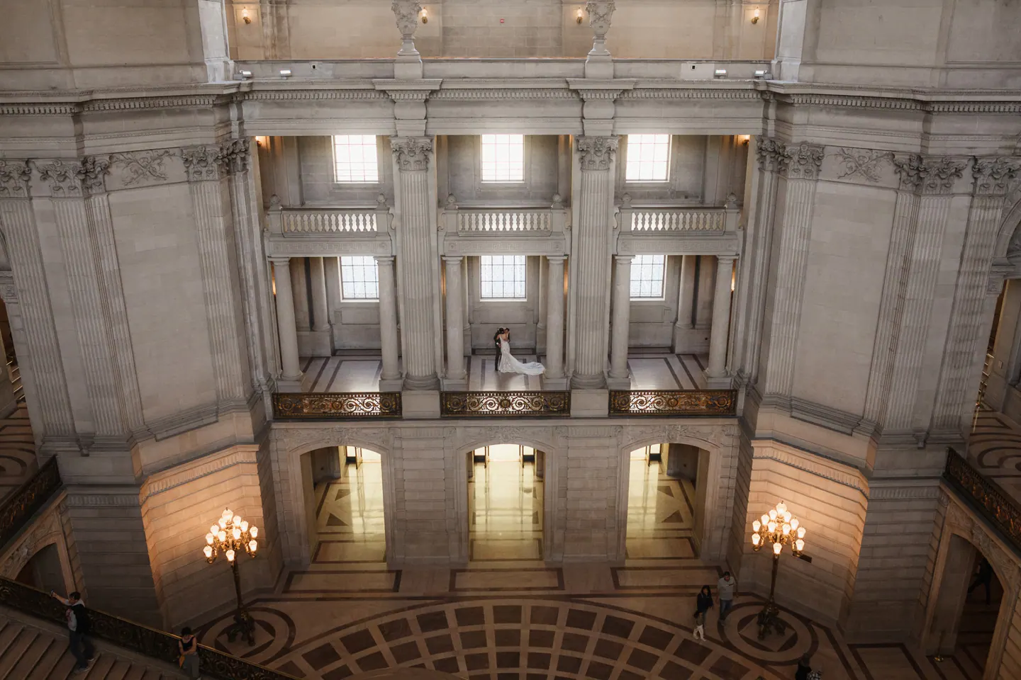 A couple framed by the architecture of San Francisco City Hall