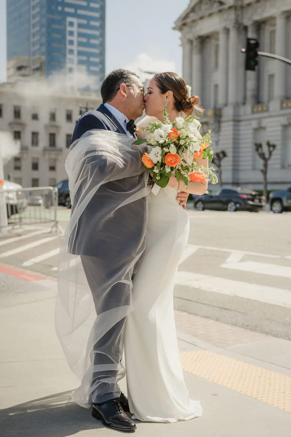 Newlyweds outside San Francisco City Hall with the building behind them