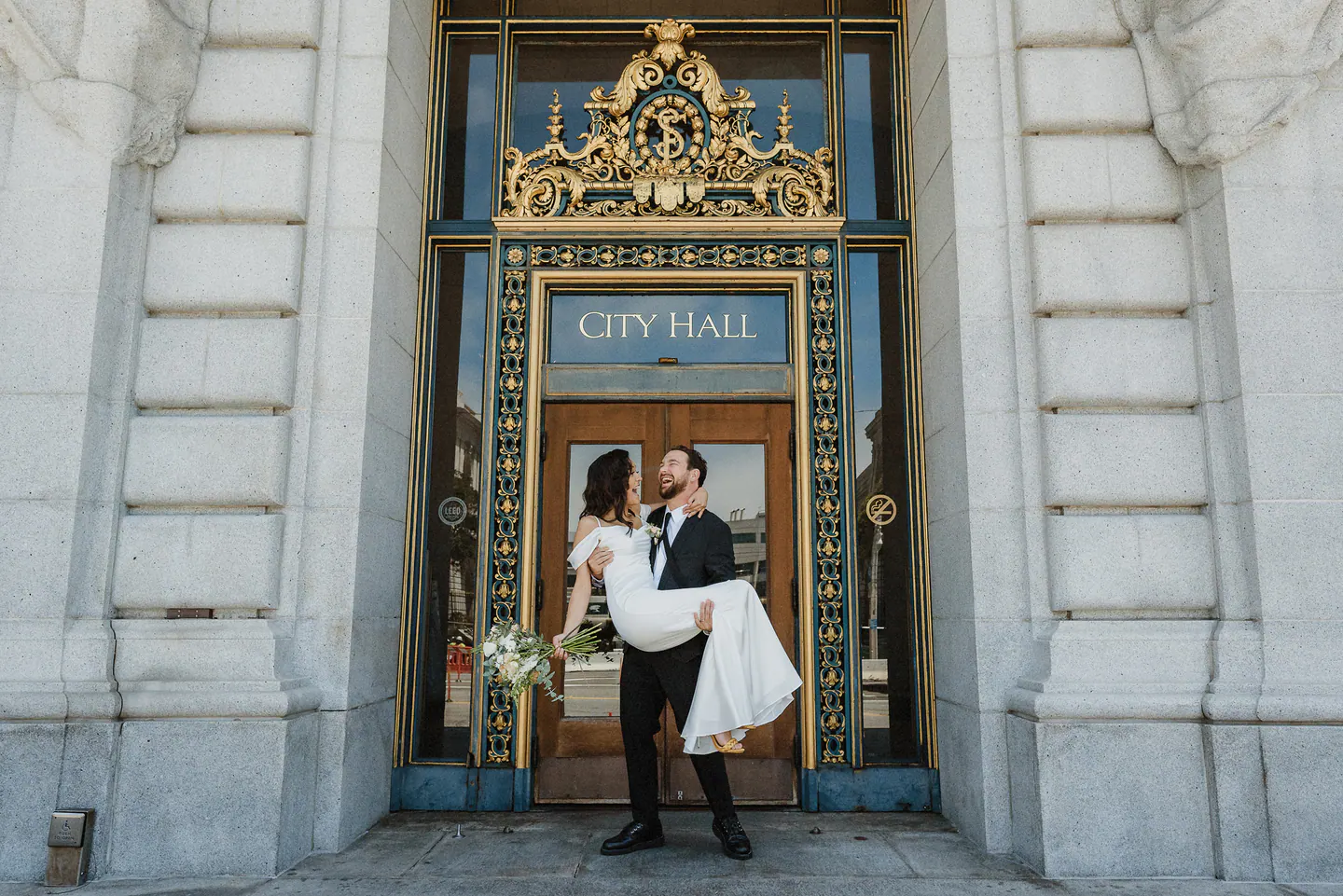 A couple entering San Francisco City Hall for their wedding