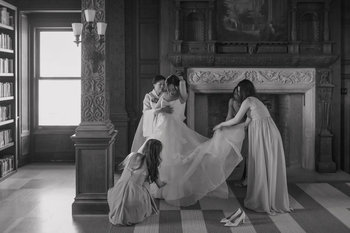 A bride and children sharing a candid moment near a fireplace
