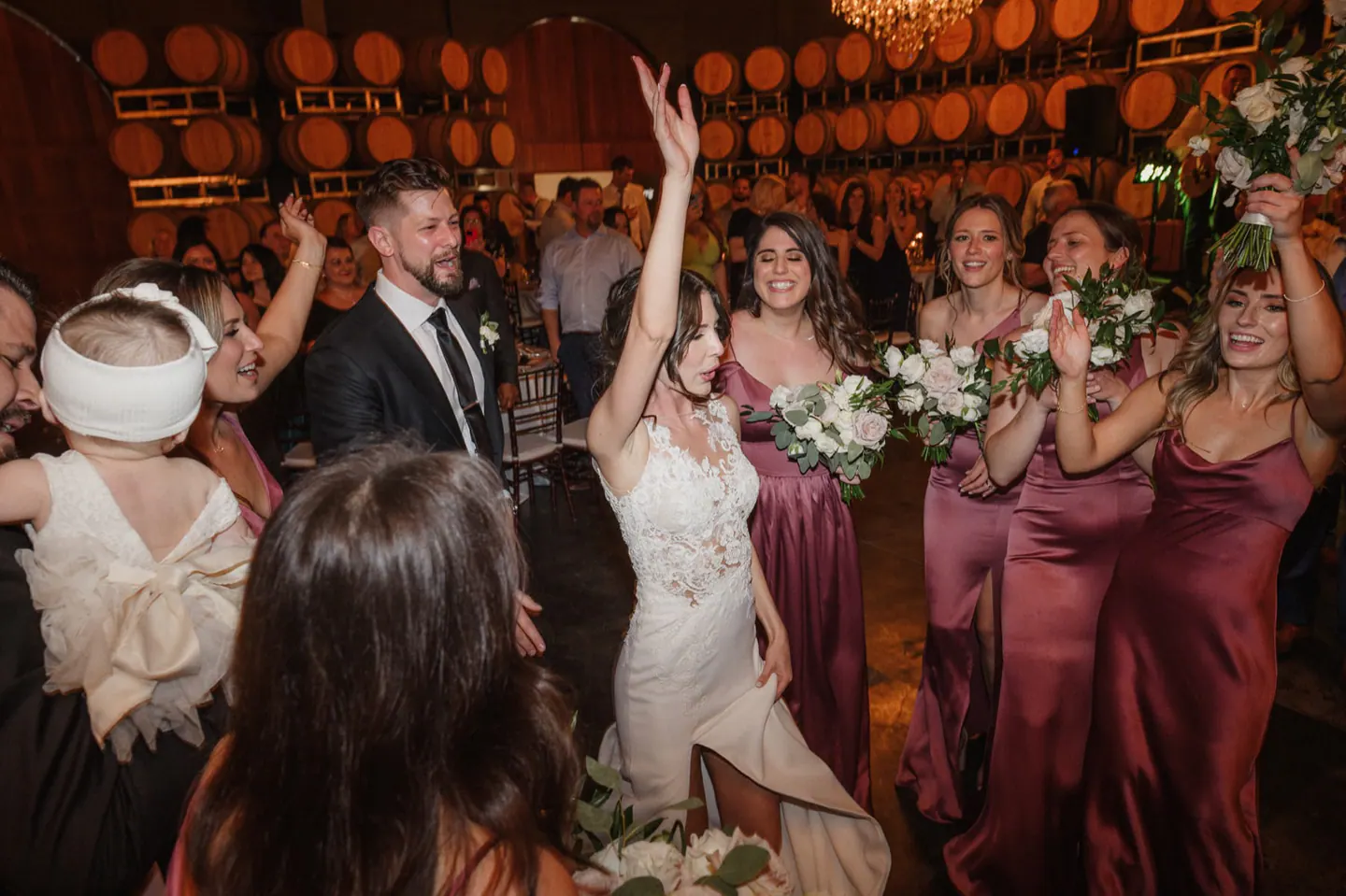 A joyful candid moment in the middle of a wedding dance floor