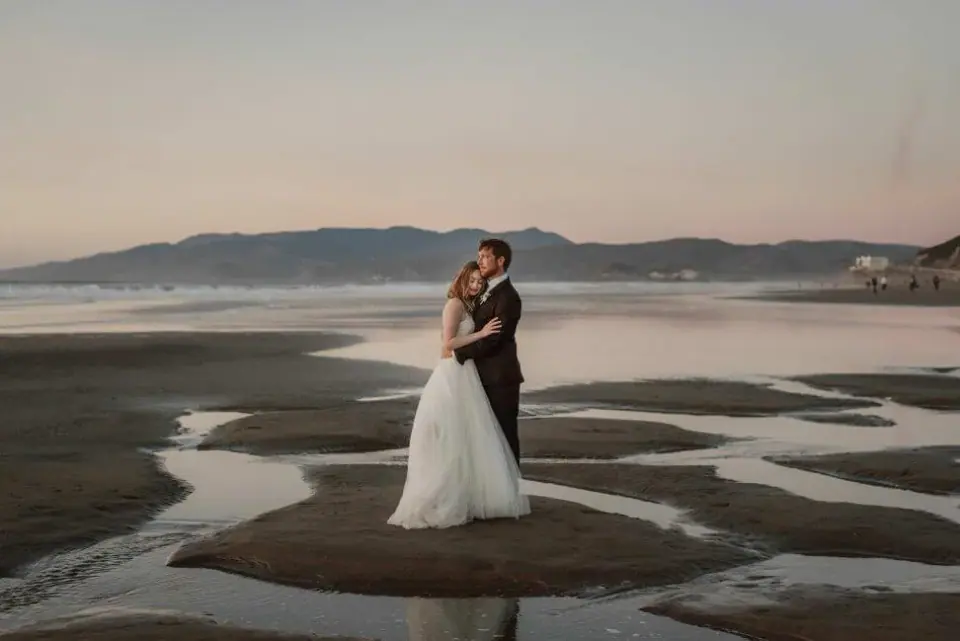 A couple embracing beside coastal tidal flats