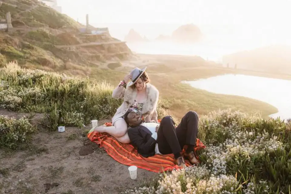 A newlywed picnic on a bluff above the ocean