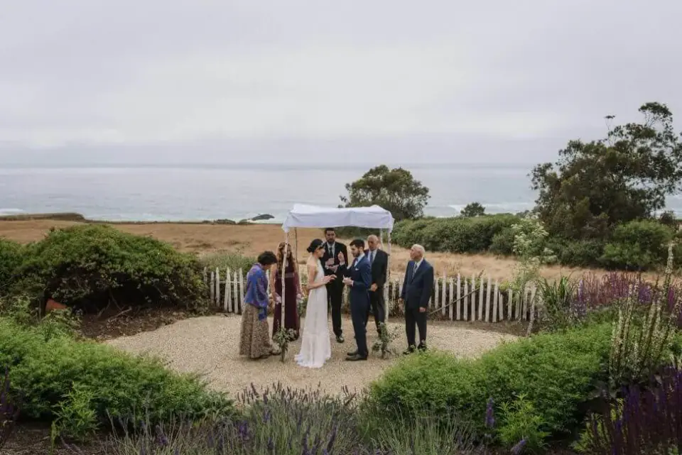 Guests gathered for a small outdoor wedding ceremony