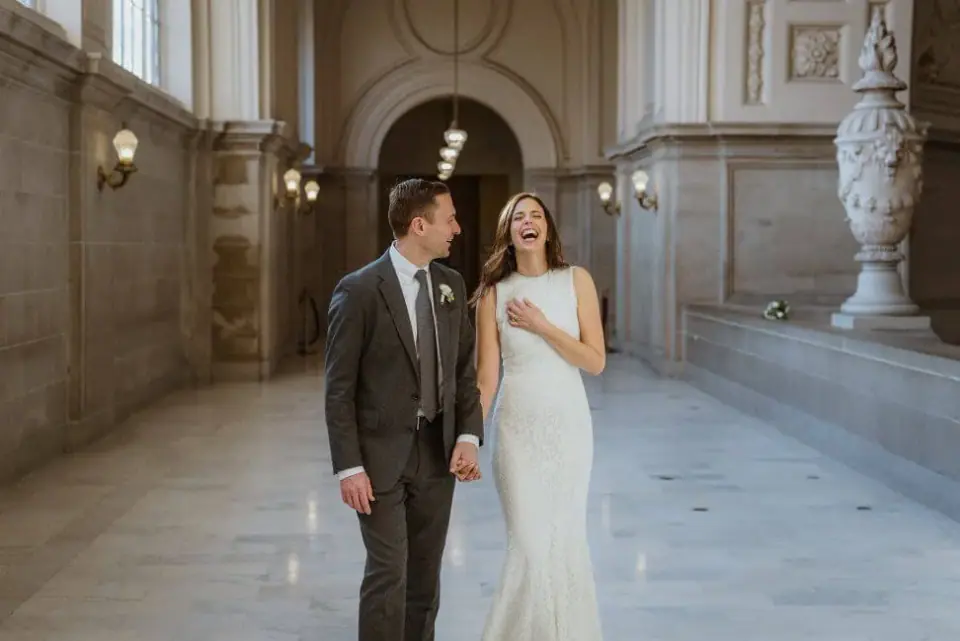 A couple walking through San Francisco City Hall after their ceremony