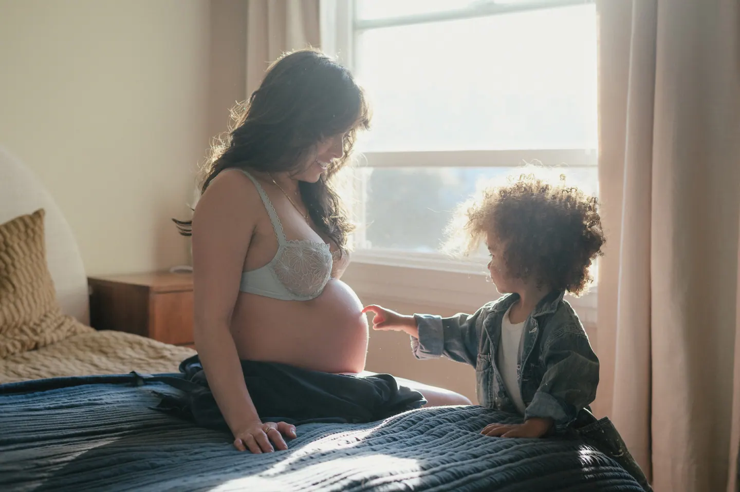 A child close to a parent during a maternity session