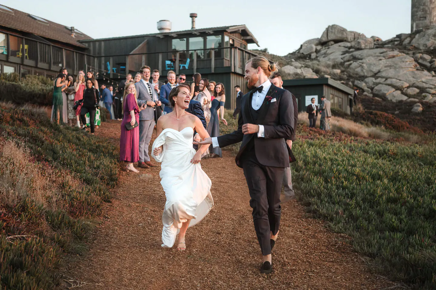 A newly married couple and guests beside the Northern California coast