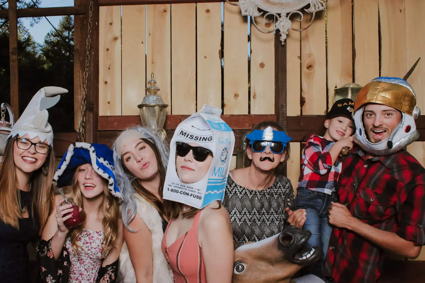 A large family group photographed together in the open-air wedding photobooth
