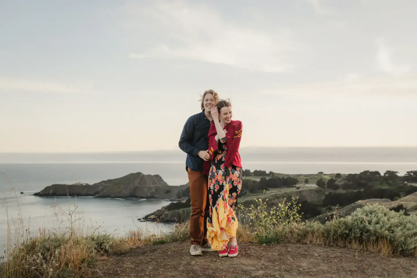 A couple together above the coast during a Marin Headlands engagement session