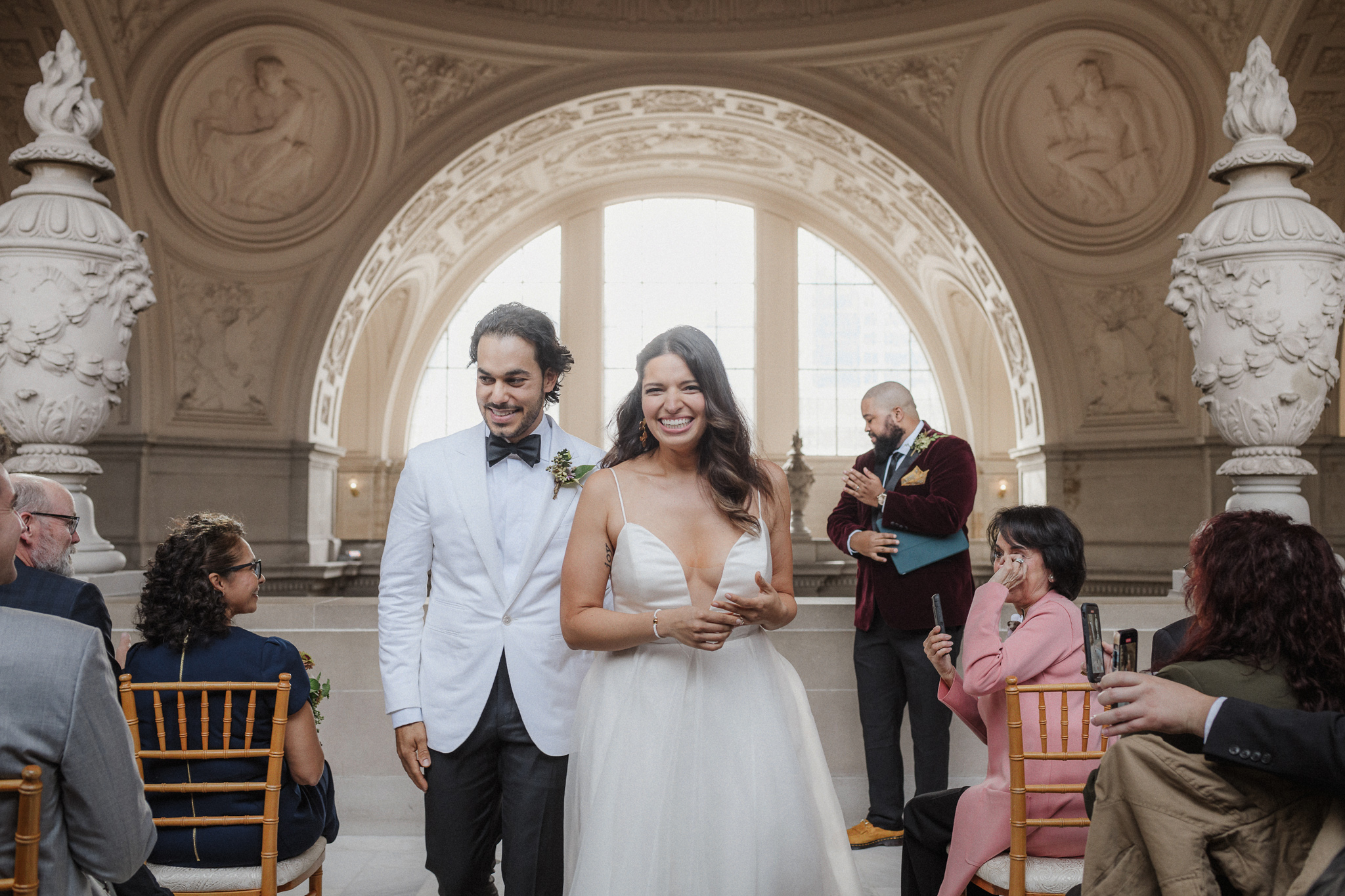 Newlyweds walking together after their San Francisco City Hall ceremony