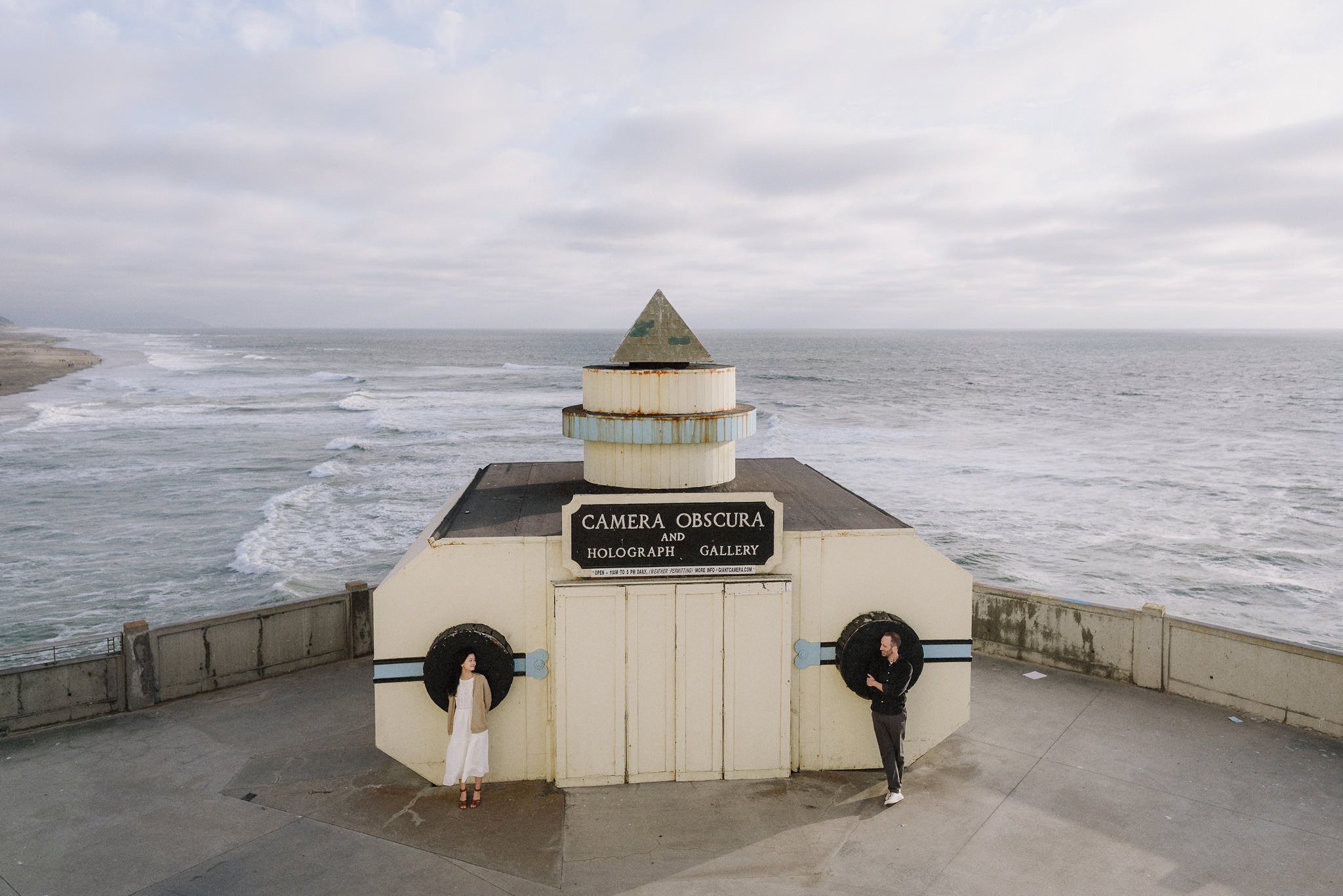 A quiet engagement portrait beside a California coastal lighthouse