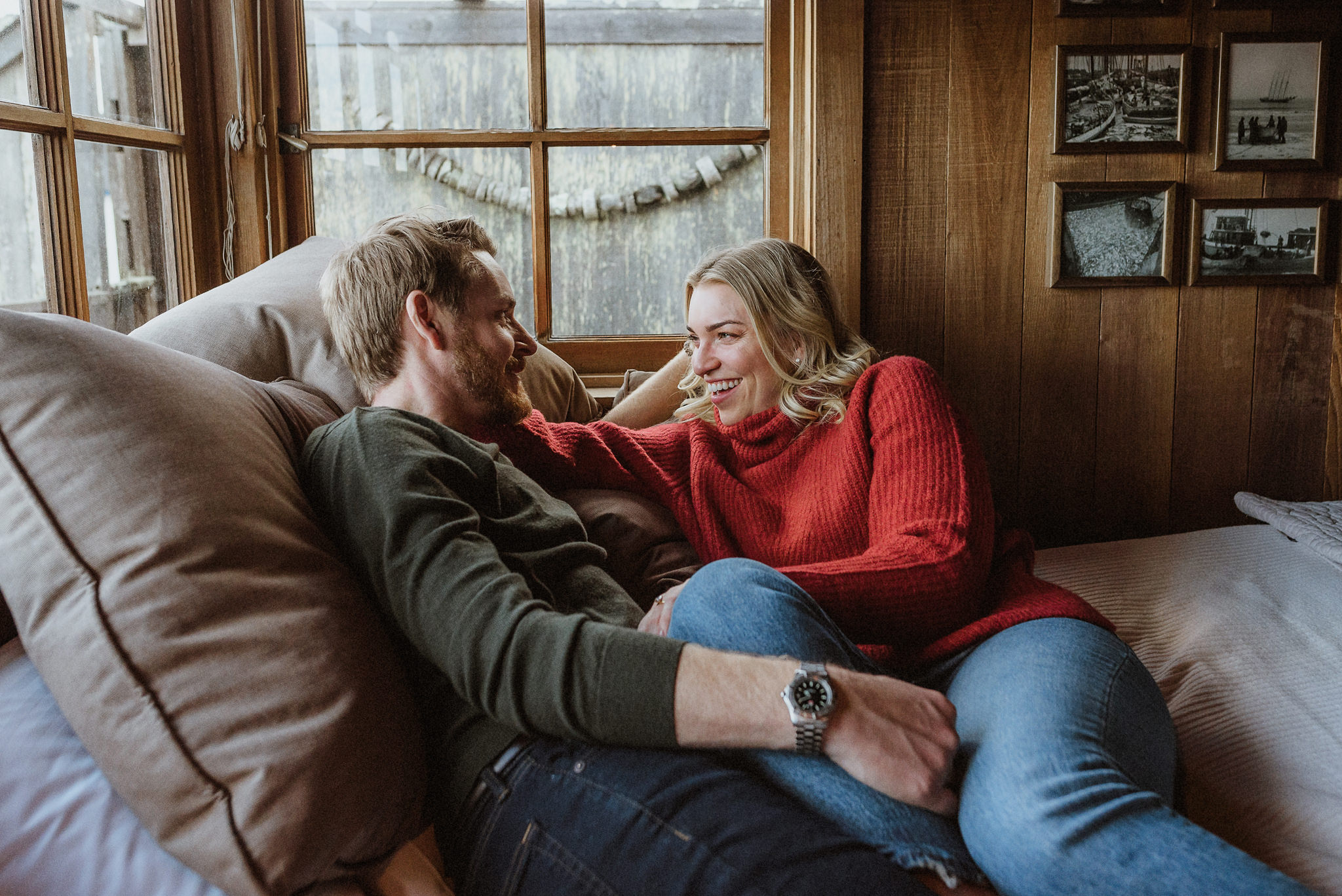 A relaxed at-home engagement photograph on the couch