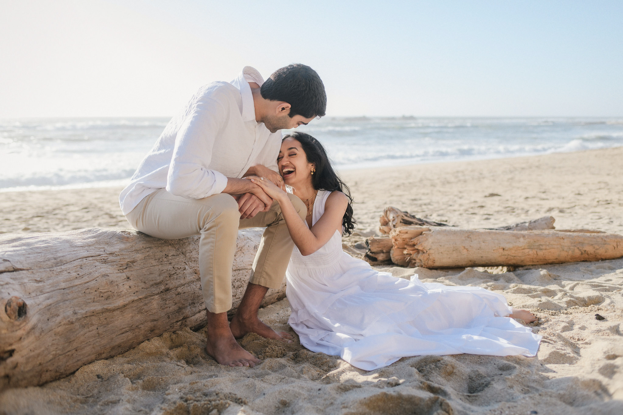 A couple kissing beside the Pacific Ocean
