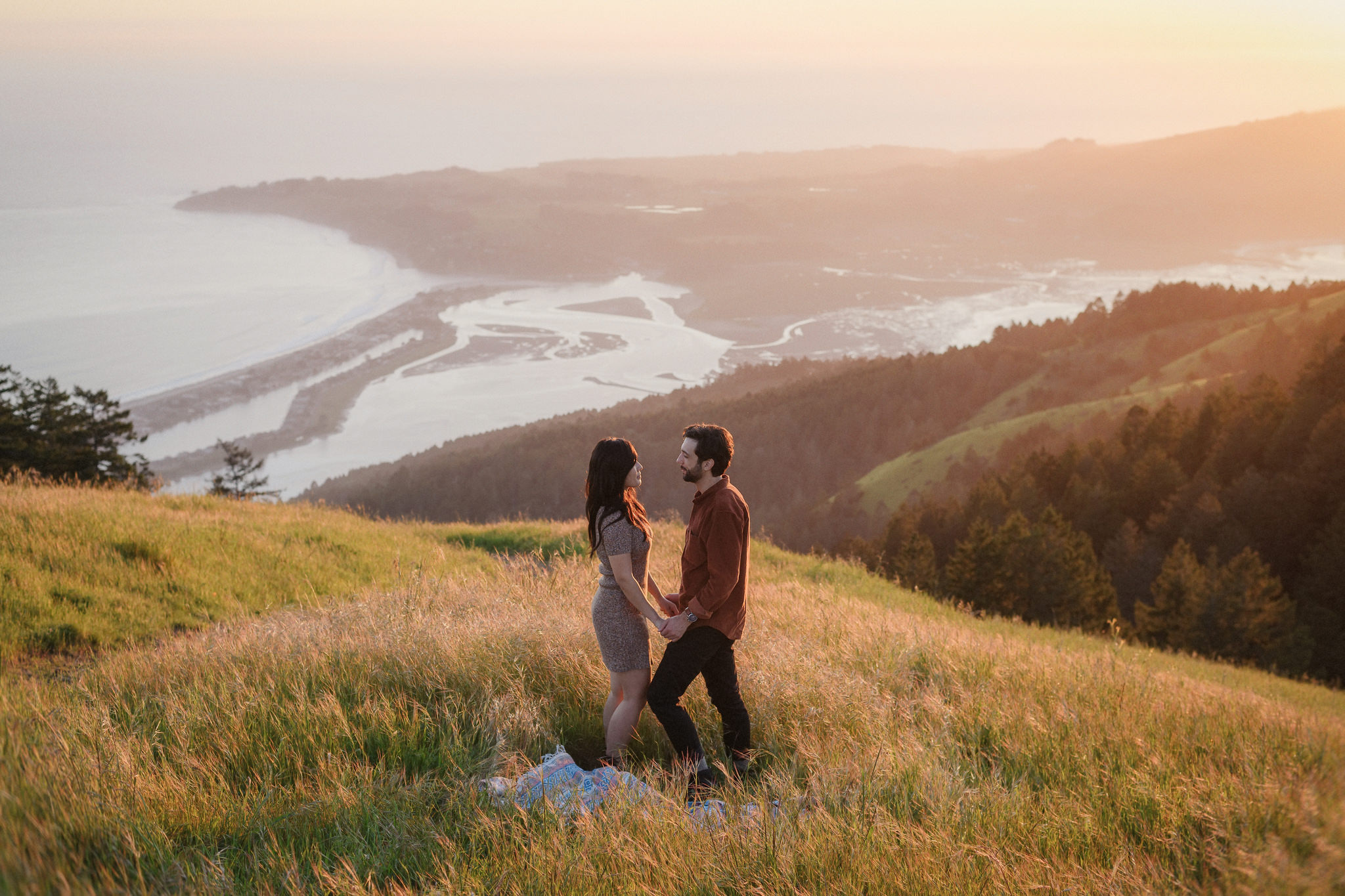 A couple together in the hills at sunset