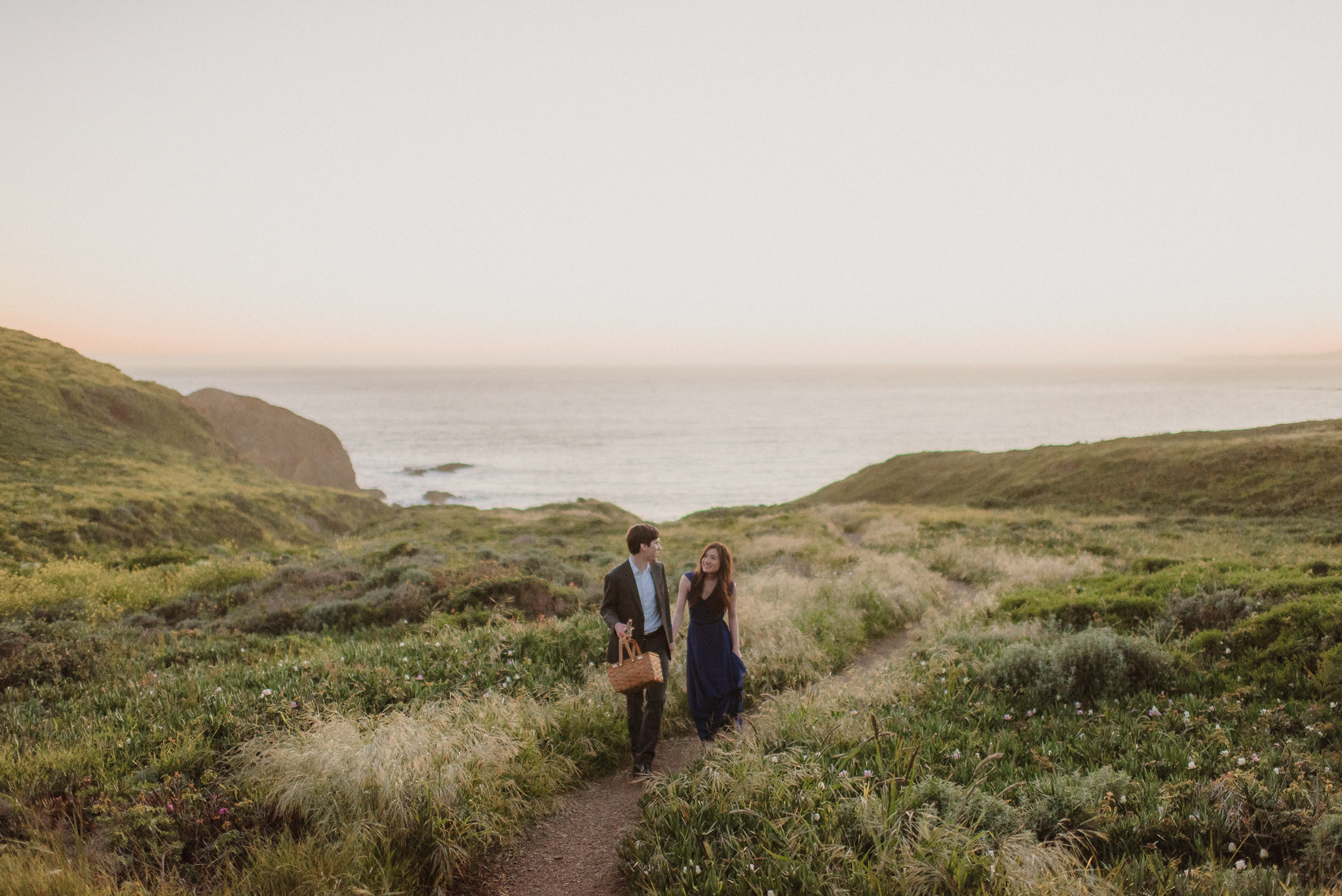 A couple walking through an open Northern California field