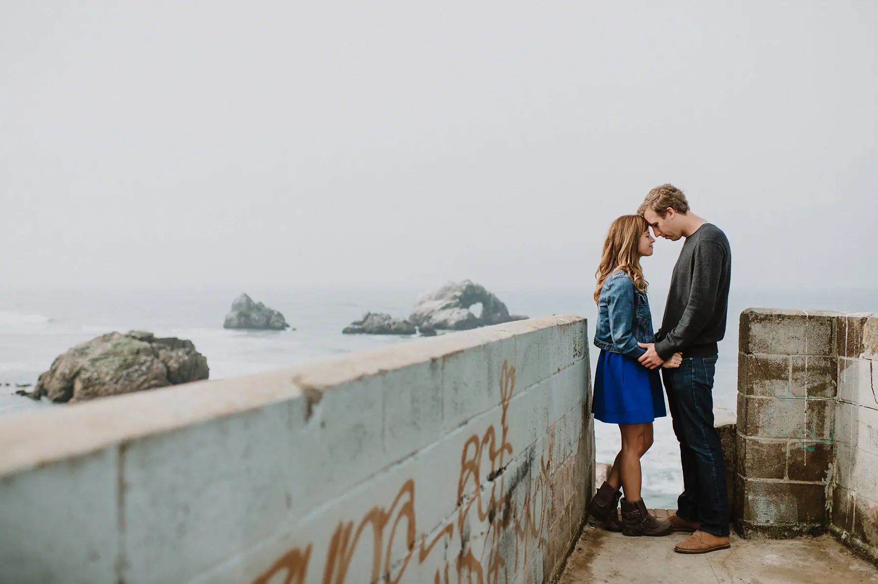 The newly engaged couple together inside a circular San Francisco art space