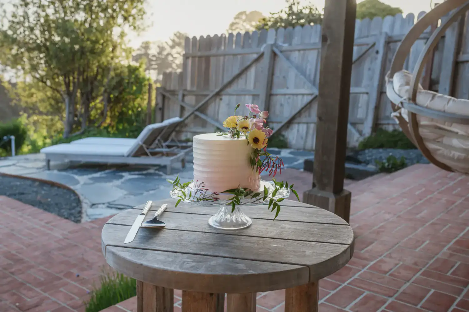 A small wedding cake waiting beside a private home on the Mendocino coast