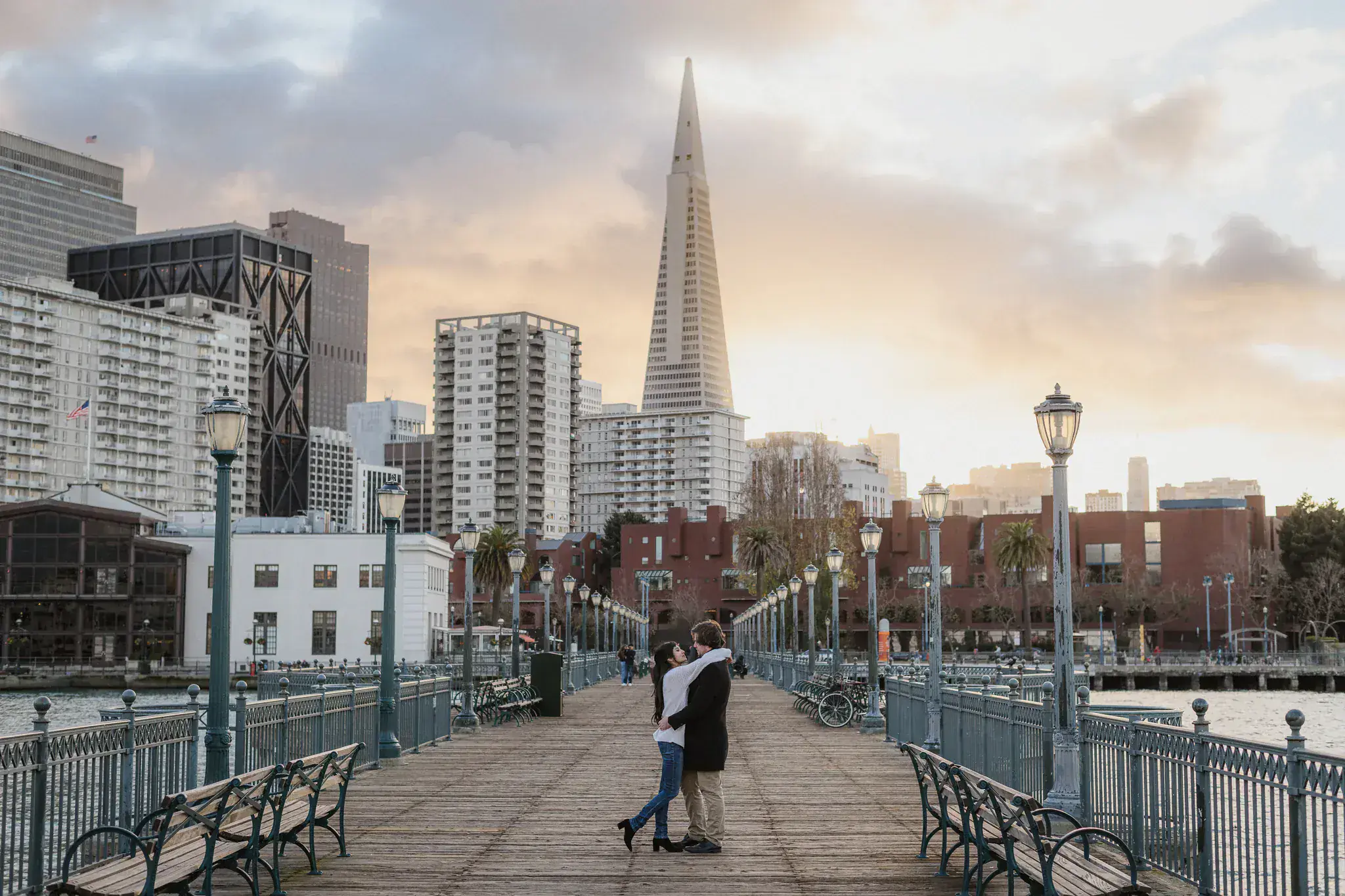 A couple together during an evening Pier 7 engagement session in San Francisco